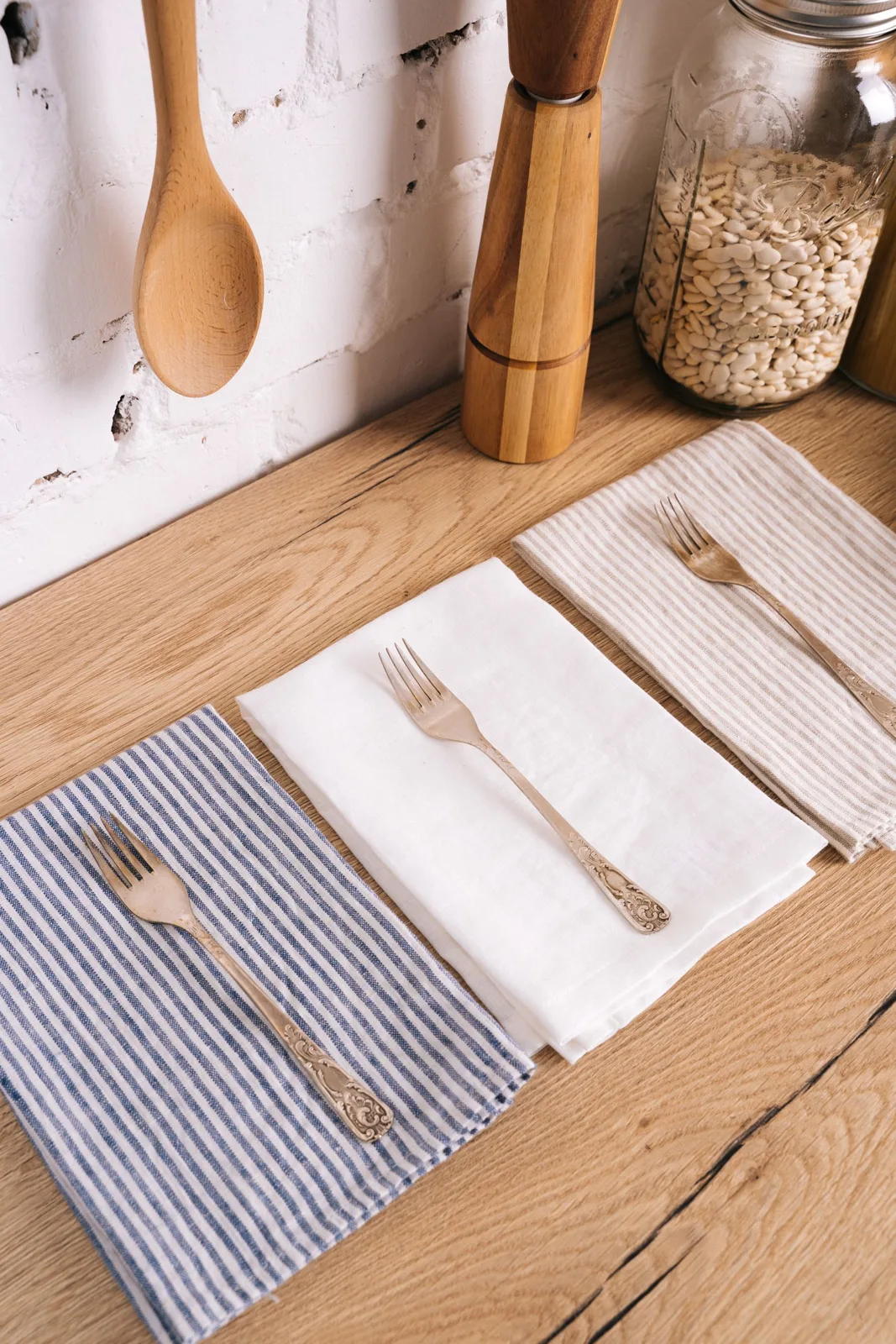 Kitchen towels beside silver cutlery